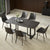 Black Sintered Stone Rectangle Dining Table with Steel Base, the Chairs Around it making an elegant look of Living Room
