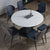 Extendable white Sintered Stone Top Dining Table with Black Base and Blue chairs around it